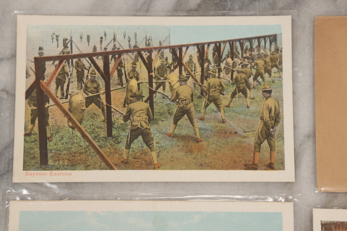 Lot 145 - Grouping Of 12 Antique World War I Soldier Training Postcards With Original Souvenir Folder, Series No. 1, Illustrated Postal Card & Novelty Co., New York