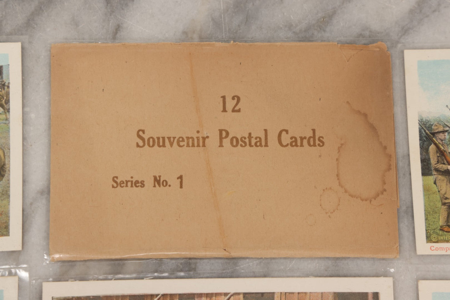 Lot 145 - Grouping Of 12 Antique World War I Soldier Training Postcards With Original Souvenir Folder, Series No. 1, Illustrated Postal Card & Novelty Co., New York
