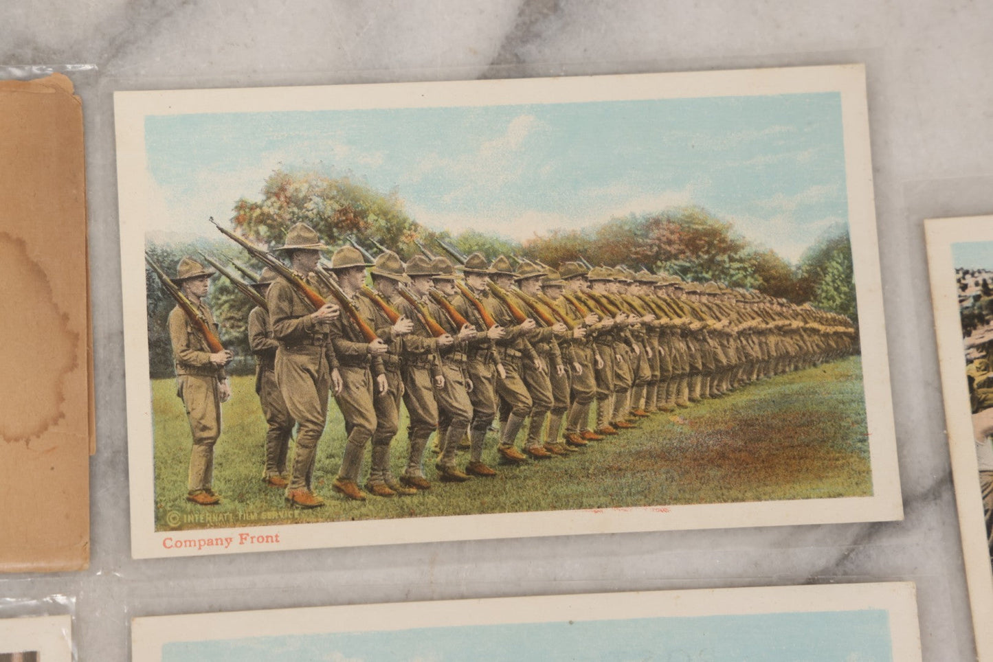 Lot 145 - Grouping Of 12 Antique World War I Soldier Training Postcards With Original Souvenir Folder, Series No. 1, Illustrated Postal Card & Novelty Co., New York