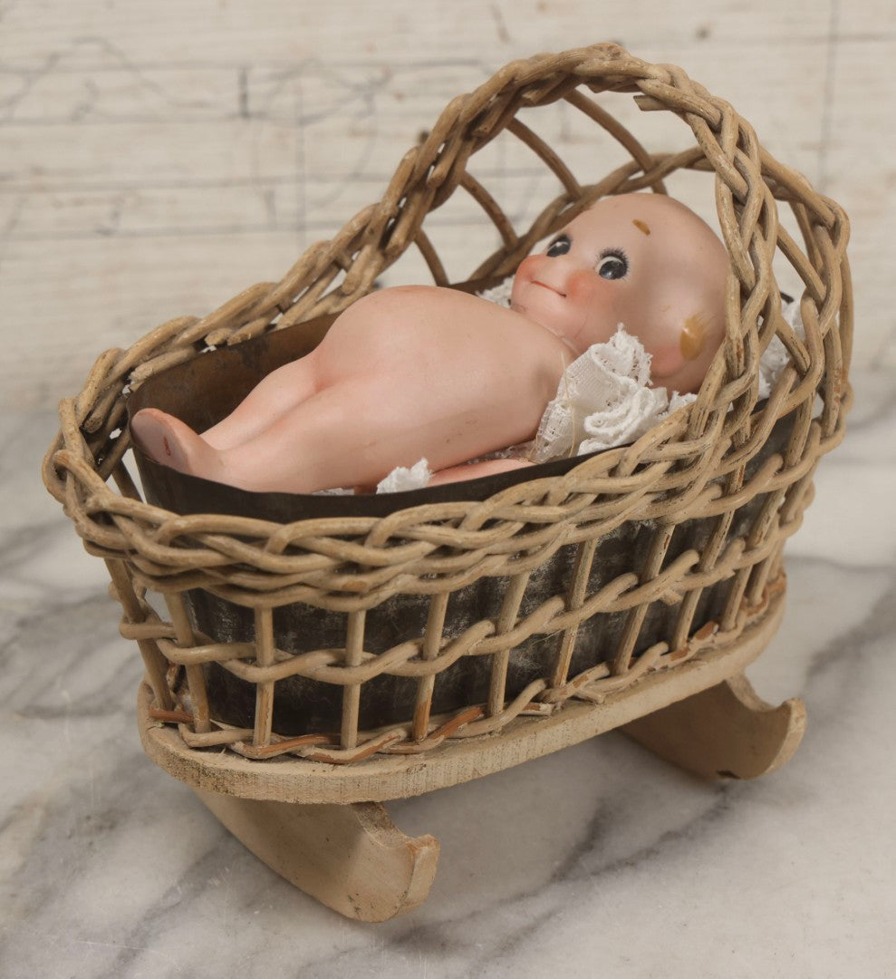 Lot 150 - Pair Of Antique Bisque Kewpie Dolls, One In Wicker Rocking Crib With Lace Bedding