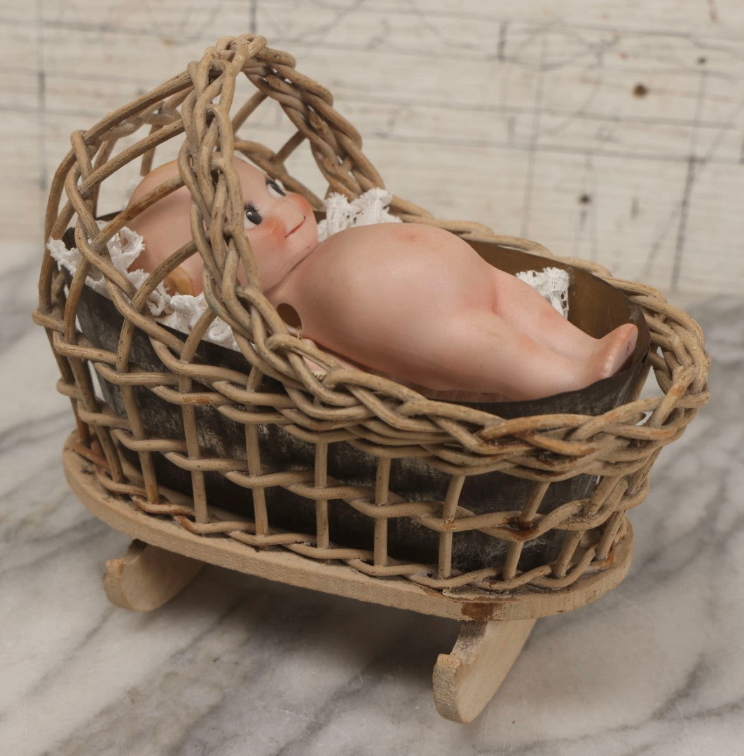 Lot 150 - Pair Of Antique Bisque Kewpie Dolls, One In Wicker Rocking Crib With Lace Bedding
