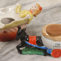 Lot 156 - Pair Of Vintage Novelty Porcelain Ashtrays — Woman Lifting Dress, Marked Patent T.T., And Donkey Pulling Toilet “For Ladies,” Made In Japan