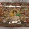Lot 031 - Antique Reverse Painted And Collaged Cigar Bands Glass Tray With Portrait Of Woman And Red Felt Backing, 8-7/8" x 5"