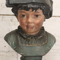 Lot 032 - Antique Hand Painted Chalkware Bust Of Boy In Green Ruffle Collared Shirt And Folded Paper Style Hat With Black Band And Green Top, 15" H