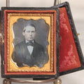 Lot 045 - Antique 1/9th Plate Daguerreotype Photograph Of Young Man In Bowtie, In Full Split Leatherette Union Case