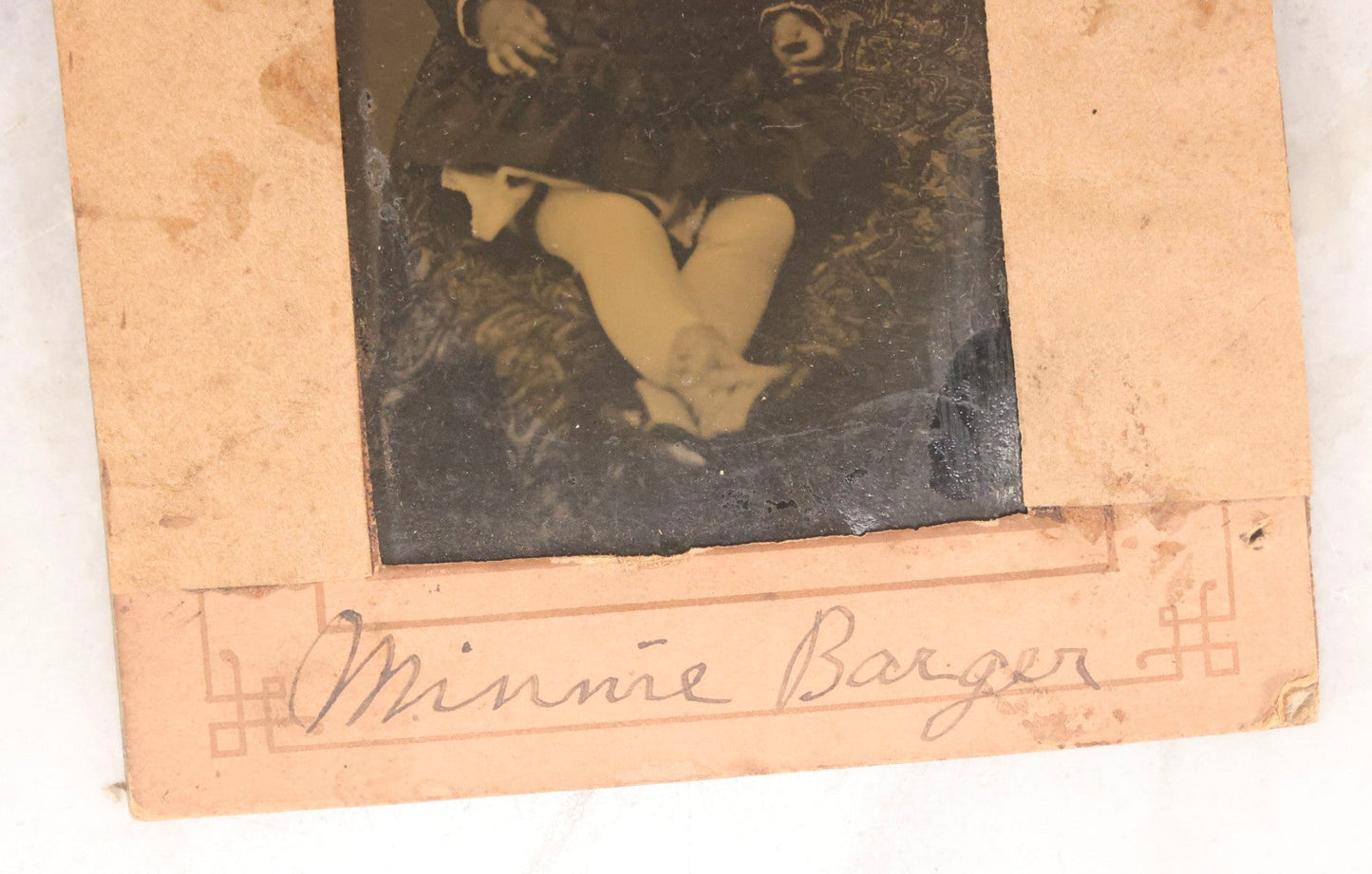 Lot 087 - Antique Tintype Photograph Of Baby In Mother's Lap, A “Not-So-Hidden Mother” Portrait, Identified As Minnie Barger, Daughter Of John J. And Elma L. Barger, In Makeshift Paper Frame