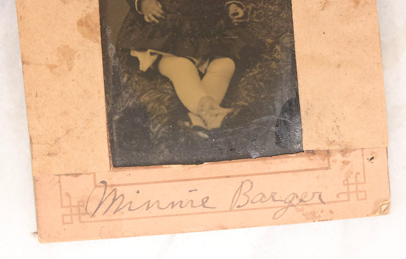 Lot 087 - Antique Tintype Photograph Of Baby In Mother's Lap, A “Not-So-Hidden Mother” Portrait, Identified As Minnie Barger, Daughter Of John J. And Elma L. Barger, In Makeshift Paper Frame