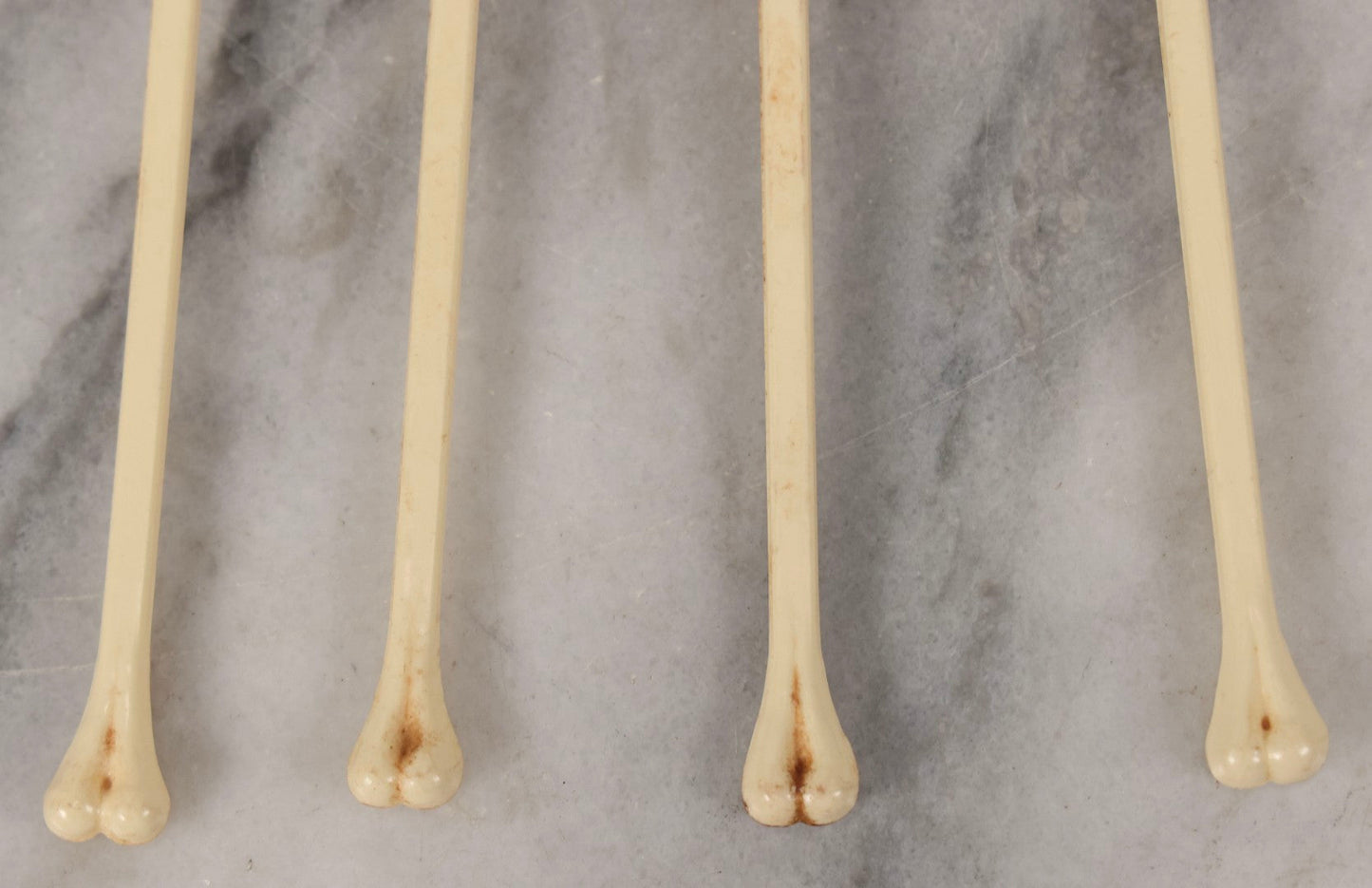 Lot 095 - Grouping Of Four Vintage Molded Plastic Skull-And-Bone Swizzle Stick Cocktail Stirrers With Rhinestone Eyes, Circa 1950s–1960s 6-3/4" L Each