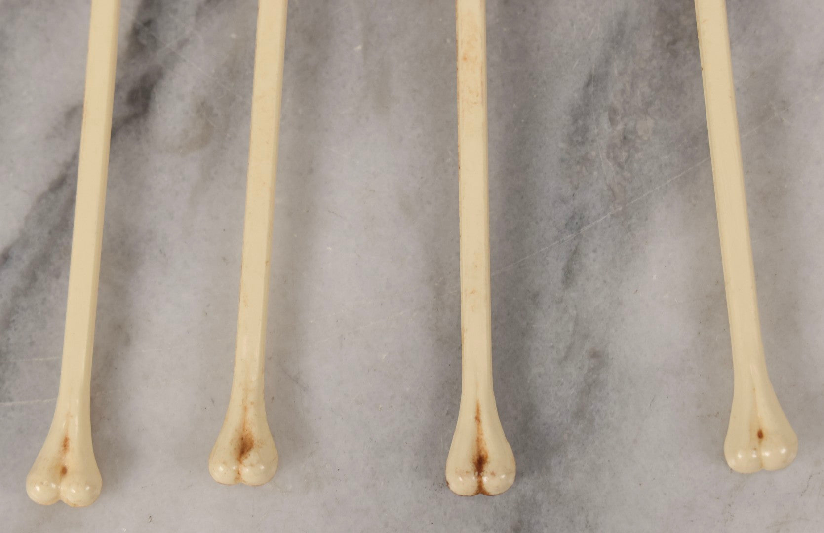 Lot 095 - Grouping Of Four Vintage Molded Plastic Skull-And-Bone Swizzle Stick Cocktail Stirrers With Rhinestone Eyes, Circa 1950s–1960s 6-3/4" L Each