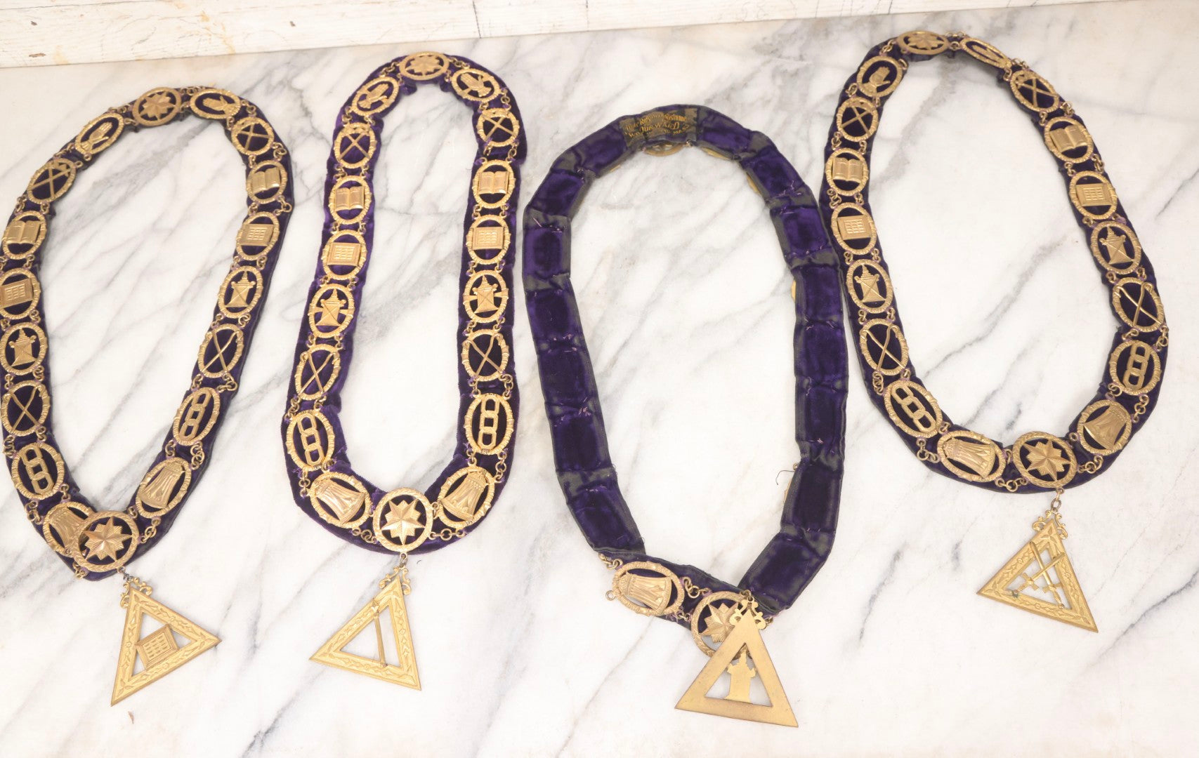 Lot 109 - Grouping Of Four Antique Odd Fellows I.O.O.F.. Purple Chain Collars By Harding Uniform & Regalia Co., Boston, And Fuller Regalia & Costume, Worcester, Massachusetts, With Symbolic Medallions