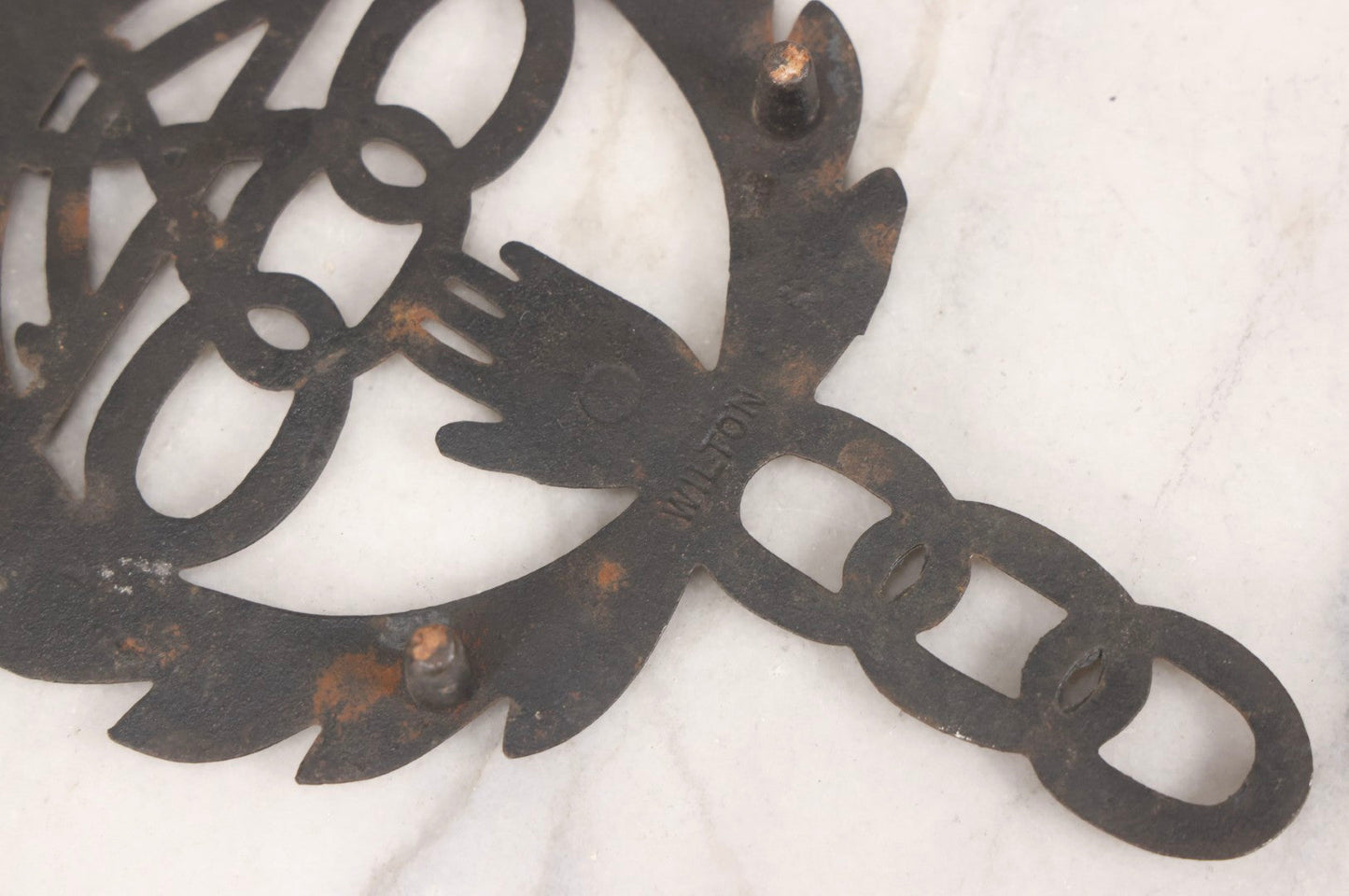 Lot 112 - Vintage Reproduction Cast Iron Odd Fellows I.O.O.F.. Trivet With Three Links, F.L.T., And Heart-In-Hand, Marked Wilton, Circa Mid-20th Century