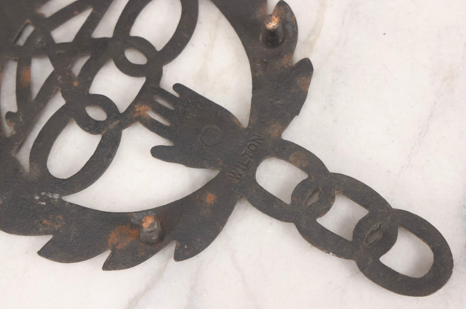 Lot 112 - Vintage Reproduction Cast Iron Odd Fellows I.O.O.F.. Trivet With Three Links, F.L.T., And Heart-In-Hand, Marked Wilton, Circa Mid-20th Century