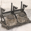 Lot 120 - Antique Cast Iron Double Inkwell Stand With Ornate Geometric And Star Decoration, Integrated Lids, Pen Rests, And Letter Holder, With Original Glass Inkwells, Vintage Black Paint Restoration