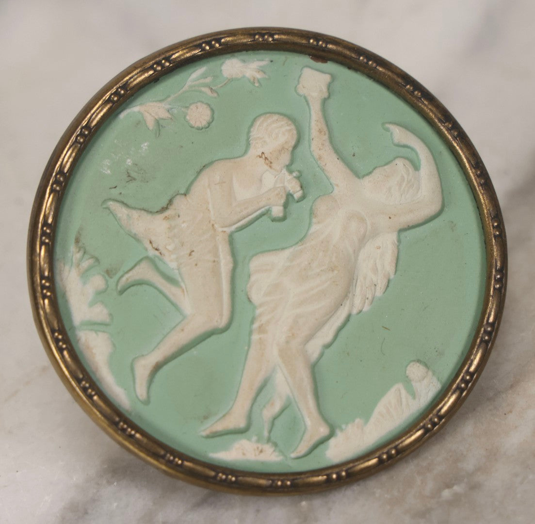 Lot 127 - Pair Of Antique Brass-Mounted Jasperware-Style Hatpins Or Brooches With Dancing Classical Figures, Woman With Cup And Man Playing Flute