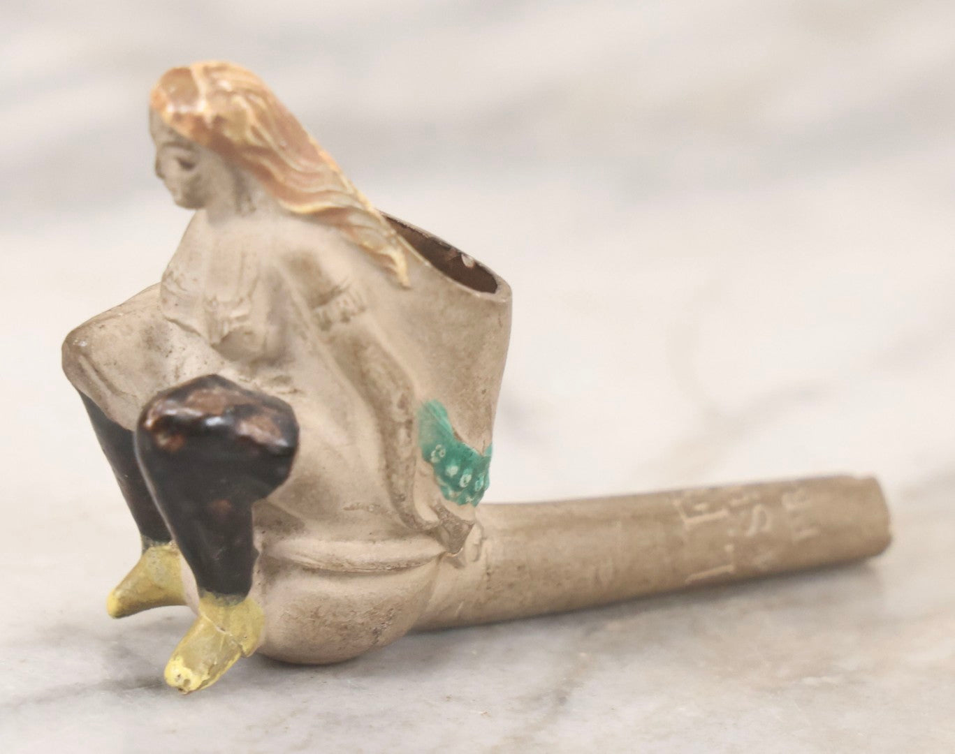 Lot 132 - Antique Painted Clay Figural Pipe Of A Busty Blonde Woman Sitting On A Chamber Pot, Stamped L. Fiolet, St. Omer, France, Note Stem Broken, 3-1/8" L
