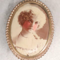 Lot 133 - Antique Celluloid Portrait Brooch With Hand-Tinted Photograph Of Young Woman With Rosy Cheeks In Brass Bezel