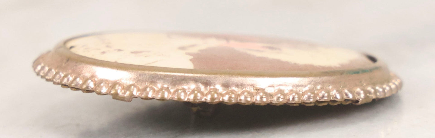 Lot 133 - Antique Celluloid Portrait Brooch With Hand-Tinted Photograph Of Young Woman With Rosy Cheeks In Brass Bezel