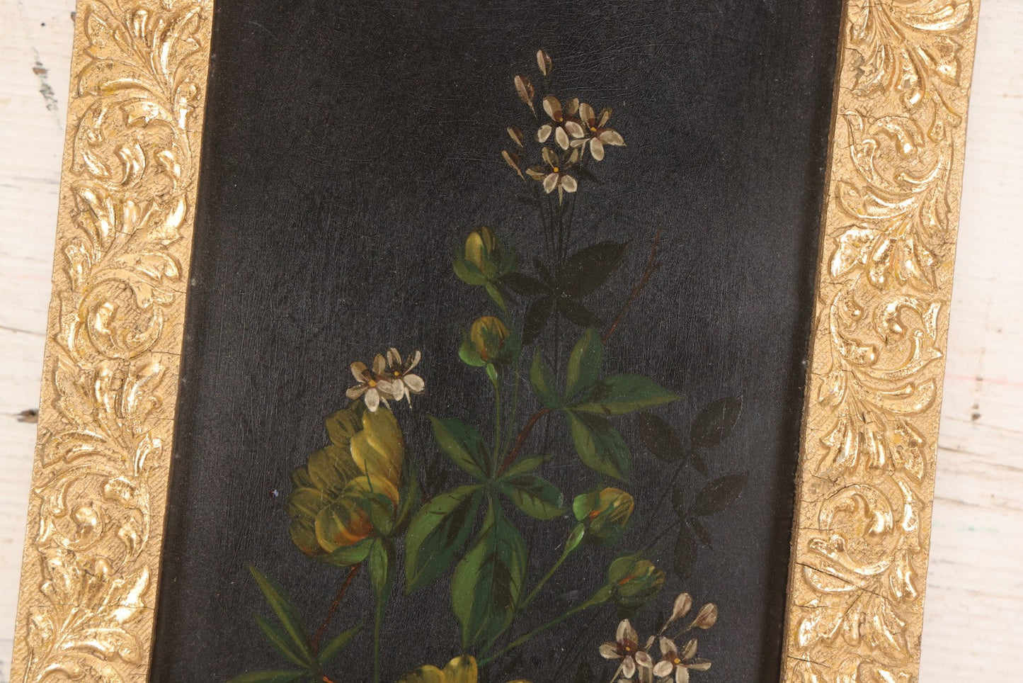 Lot 144 - Antique Oil On Board Painting Of Yellow And White Flowers On Black Background On Tin, In Gilt Wood Frame With Leaf Design, 9-3/8" x 22-1/4"