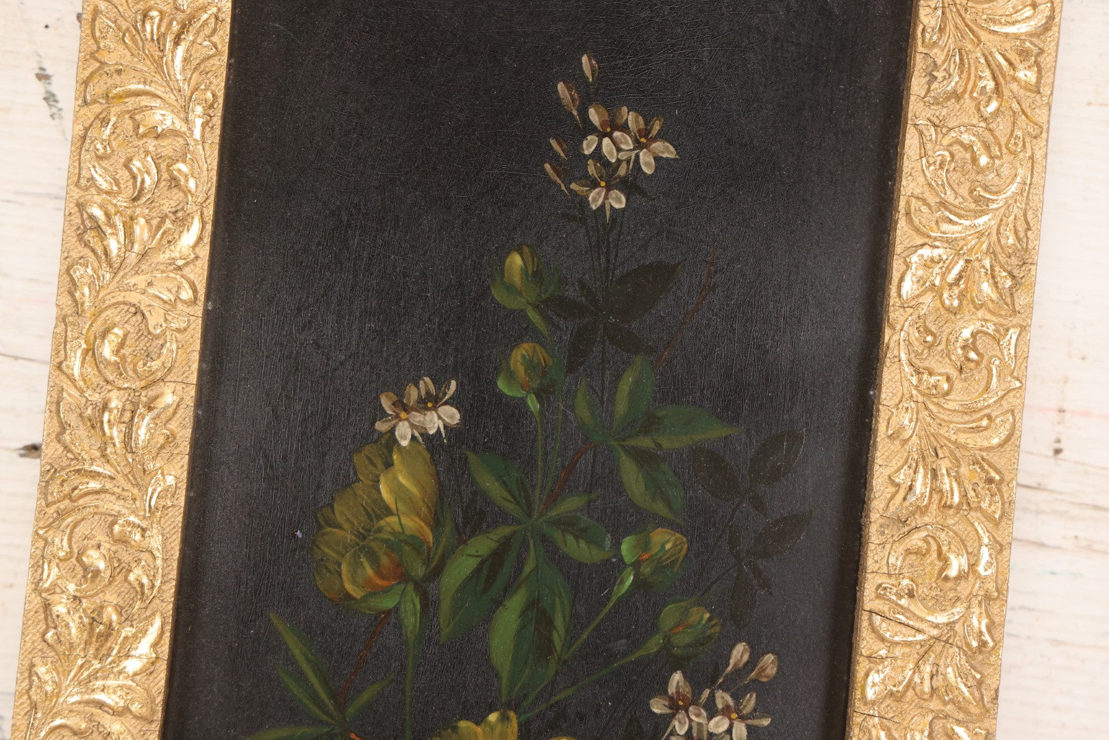 Lot 144 - Antique Oil On Board Painting Of Yellow And White Flowers On Black Background On Tin, In Gilt Wood Frame With Leaf Design, 9-3/8" x 22-1/4"