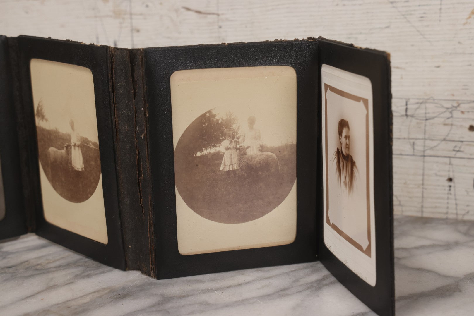 Lot 157 - Antique Quad-Fold Leatherette Photo Folder Wallet With Four Cabinet Card Photographs, Including Woman's Portraits And Children With Lamb