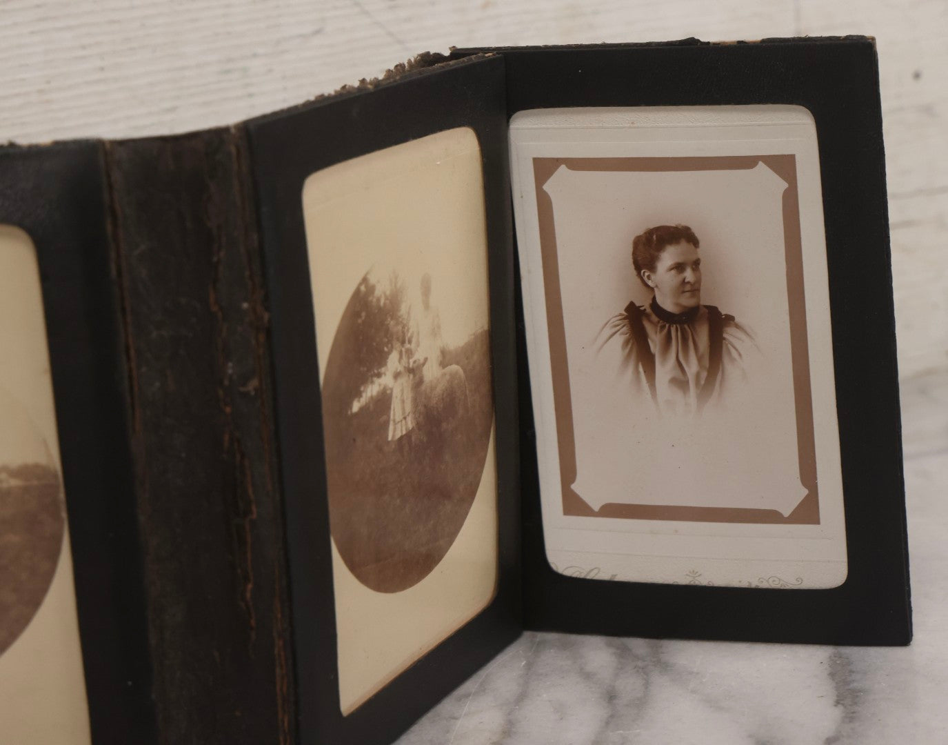 Lot 157 - Antique Quad-Fold Leatherette Photo Folder Wallet With Four Cabinet Card Photographs, Including Woman's Portraits And Children With Lamb