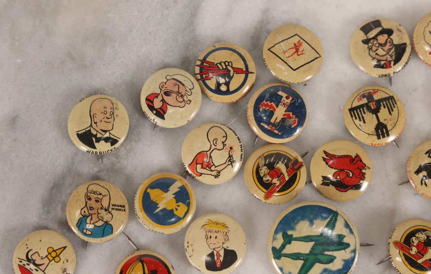 Lot 187 - Grouping Of 30 Vintage Kellogg's Pep Cereal Pinback Buttons Featuring Comic Strip Characters Like Popeye And Lord Pushbottom And World War II Military Insignia, Copyright 1946