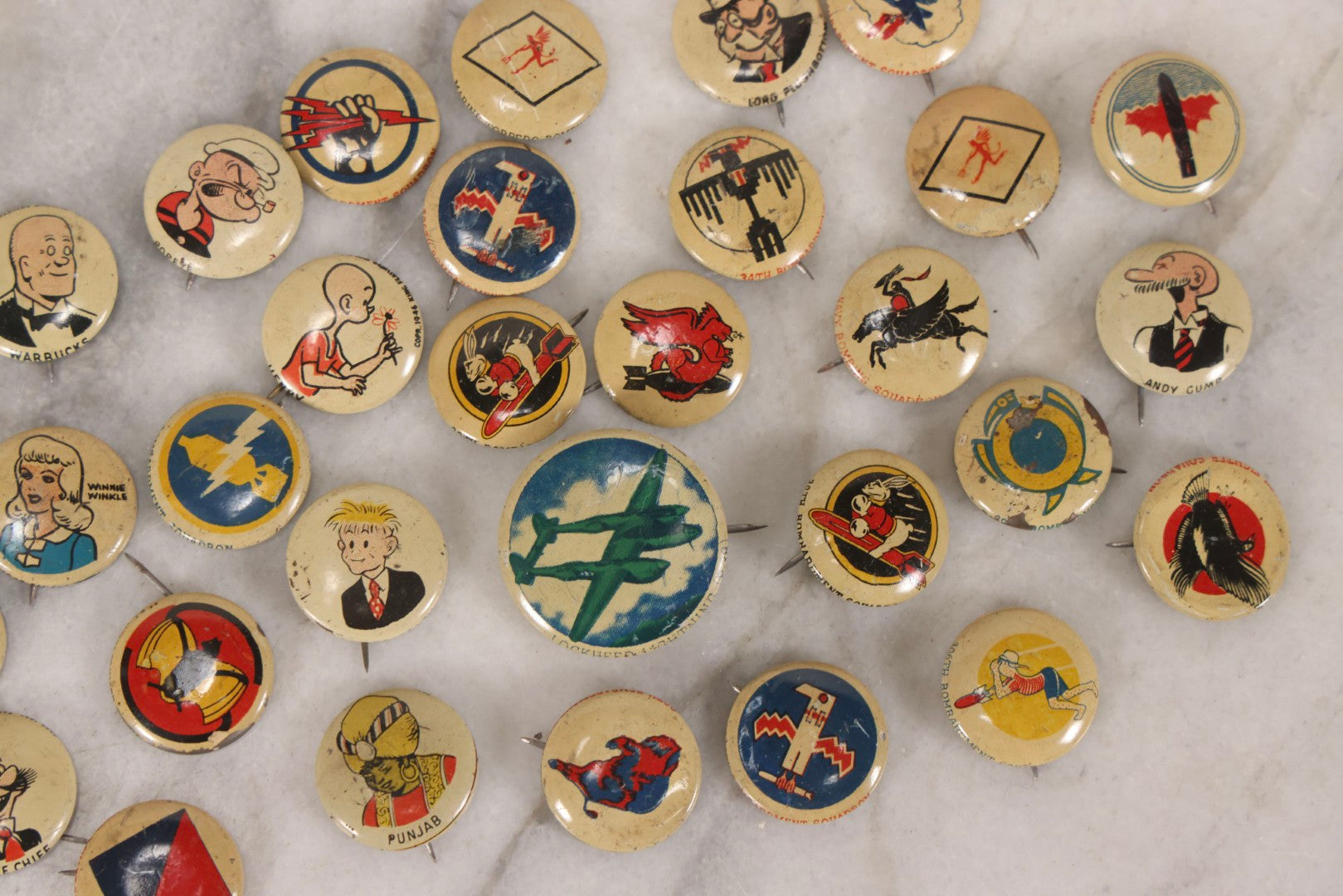 Lot 187 - Grouping Of 30 Vintage Kellogg's Pep Cereal Pinback Buttons Featuring Comic Strip Characters Like Popeye And Lord Pushbottom And World War II Military Insignia, Copyright 1946