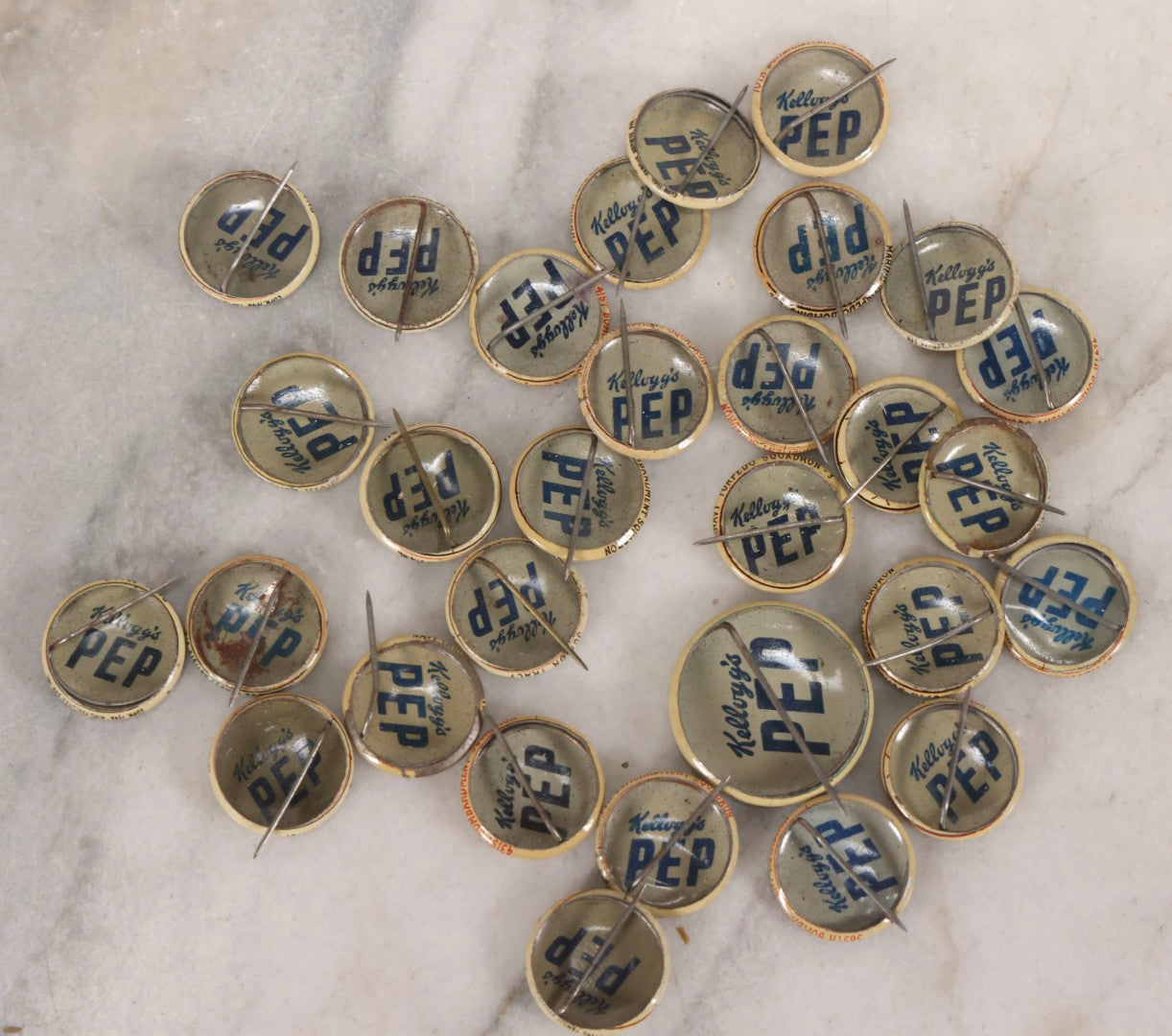 Lot 187 - Grouping Of 30 Vintage Kellogg's Pep Cereal Pinback Buttons Featuring Comic Strip Characters Like Popeye And Lord Pushbottom And World War II Military Insignia, Copyright 1946
