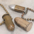 Lot 189 - Trio Of Vintage Bullet Novelties Including Two Bullet Keychains And “Lone Ranger” Toy Bullet