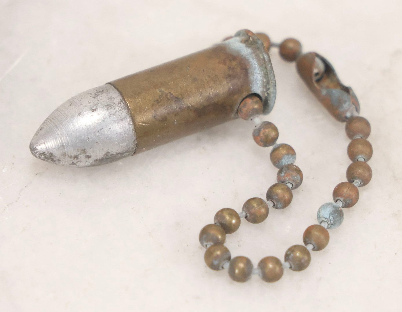 Lot 189 - Trio Of Vintage Bullet Novelties Including Two Bullet Keychains And “Lone Ranger” Toy Bullet