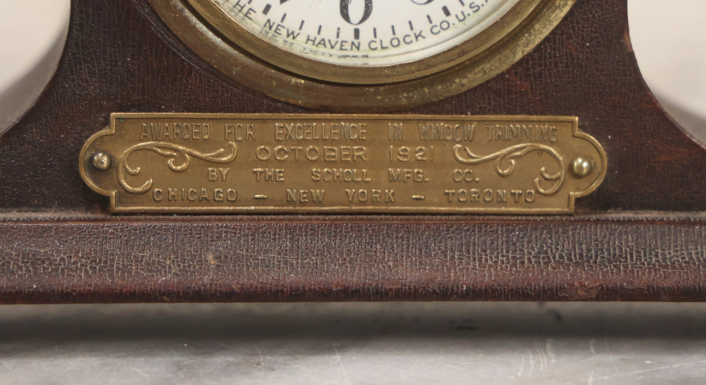 Lot 069 - Antique New Haven Clock Co. Tambour Mantel Clock Awarded For Excellence In Window Trimming, October 1921, The Scholl Mfg. Co., Untested, 3-1/2" H