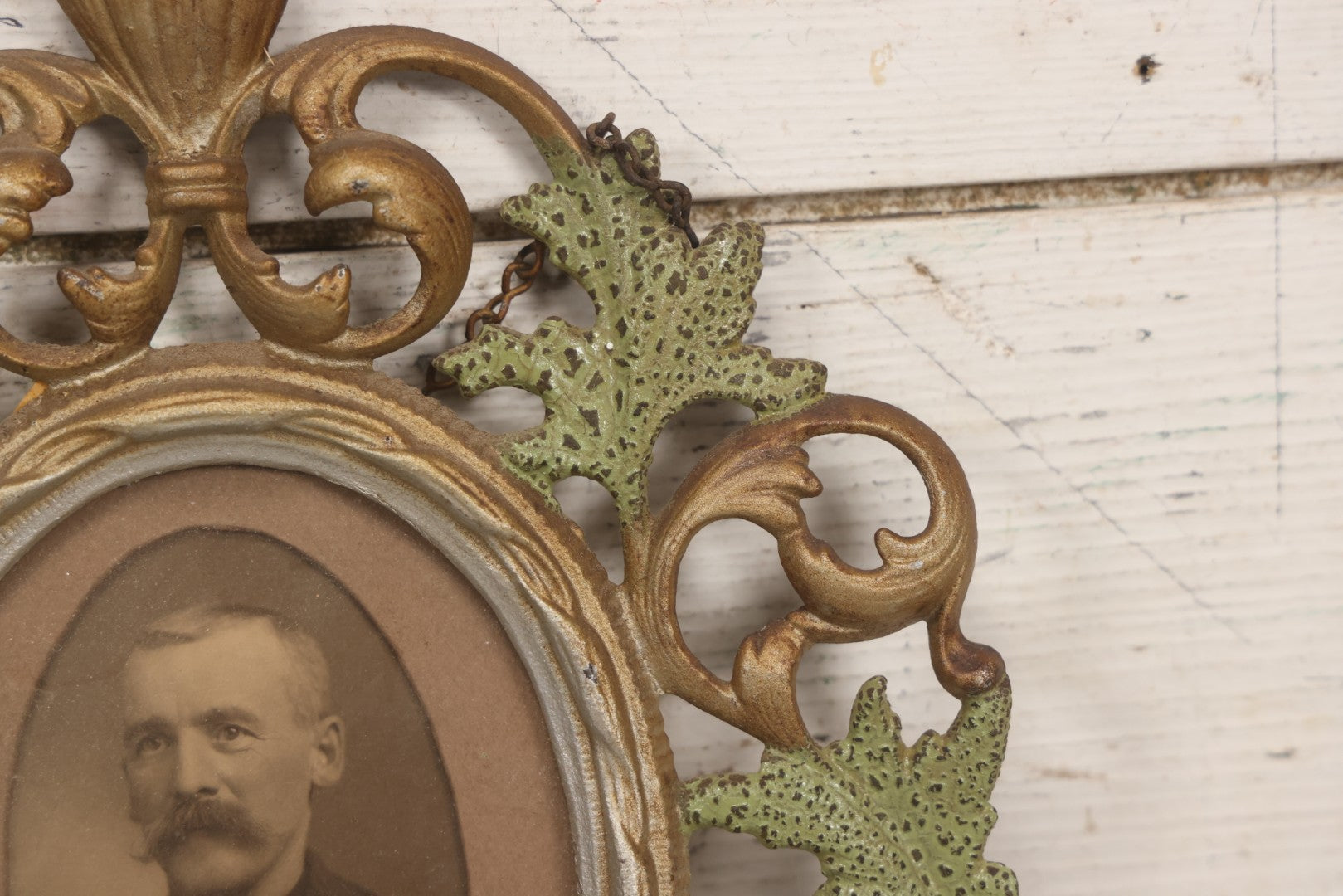 Lot 152 - Antique Decorative Cast Metal Frame With Silver, Gold, And Green Paint And Oval Portrait Of Man With Mustache