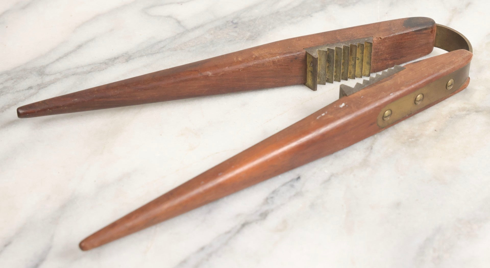 Lot 031 - Antique Wood-Handled Nutcracker With Brass Hardware, Bent Brass Spring Band, And Aggressive Brass Jaws