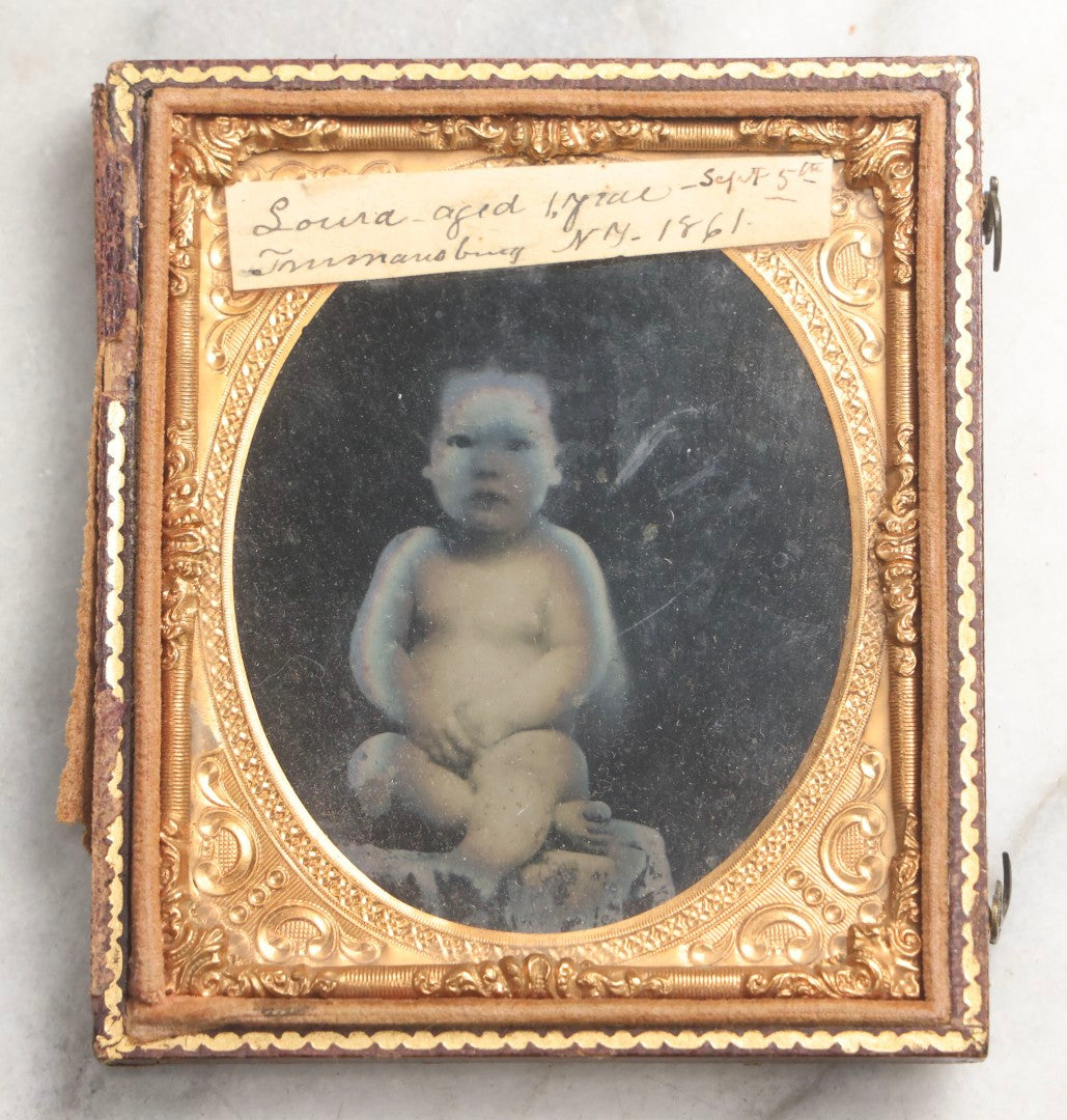 Lot 100 - Antique 1/6th Plate Ambrotype Photograph Of Naked Baby, Identified As Laura, Aged 1 Year, September 5th, 1861, In Full Split Leatherette Case With Red Pillow, Trumansburg, New York