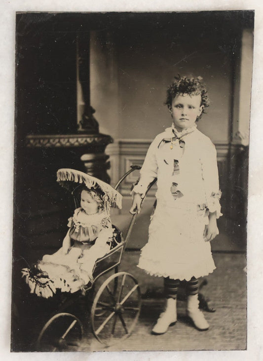 Lot 107 - Antique Tintype Photograph Of Curly-Haired Girl Standing Beside Pram With Large Toy Doll