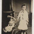 Lot 107 - Antique Tintype Photograph Of Curly-Haired Girl Standing Beside Pram With Large Toy Doll