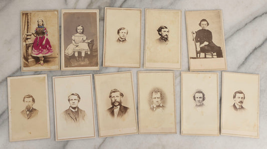 Lot 127 - Grouping Of Eleven Antique Carte De Visite C.D.V.. Photographs Including Hand-Colored Portrait Of Young Girl In Traditional Dress, Boy In Chair, Girl In Dress, And Multiple Men's Portraits