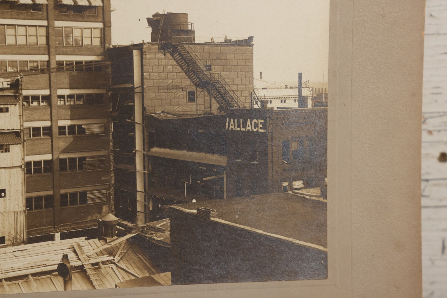 Lot 140 - Antique Boarded Photograph Of Urban Construction Scene With Multi-Story Buildings, Rooftop Water Tank, And “Wallace” Sign Visible