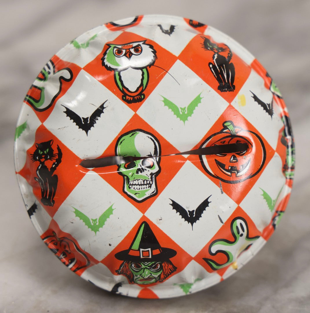 Lot 048 - Vintage Round Halloween Tin Lithograph Noisemaker With Orange And White Checkered Pattern Featuring Black Cat, Witch, Ghost, Bat, Skull, And Jack-O'-Lantern J.O.L. Characters