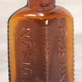 Lot 084 - Amber Poison Bottle With Poison Ribs, Tartar Emetic Paper Label, Eli Lilly & Co., Indianapolis, Indiana, 2-3/4" H