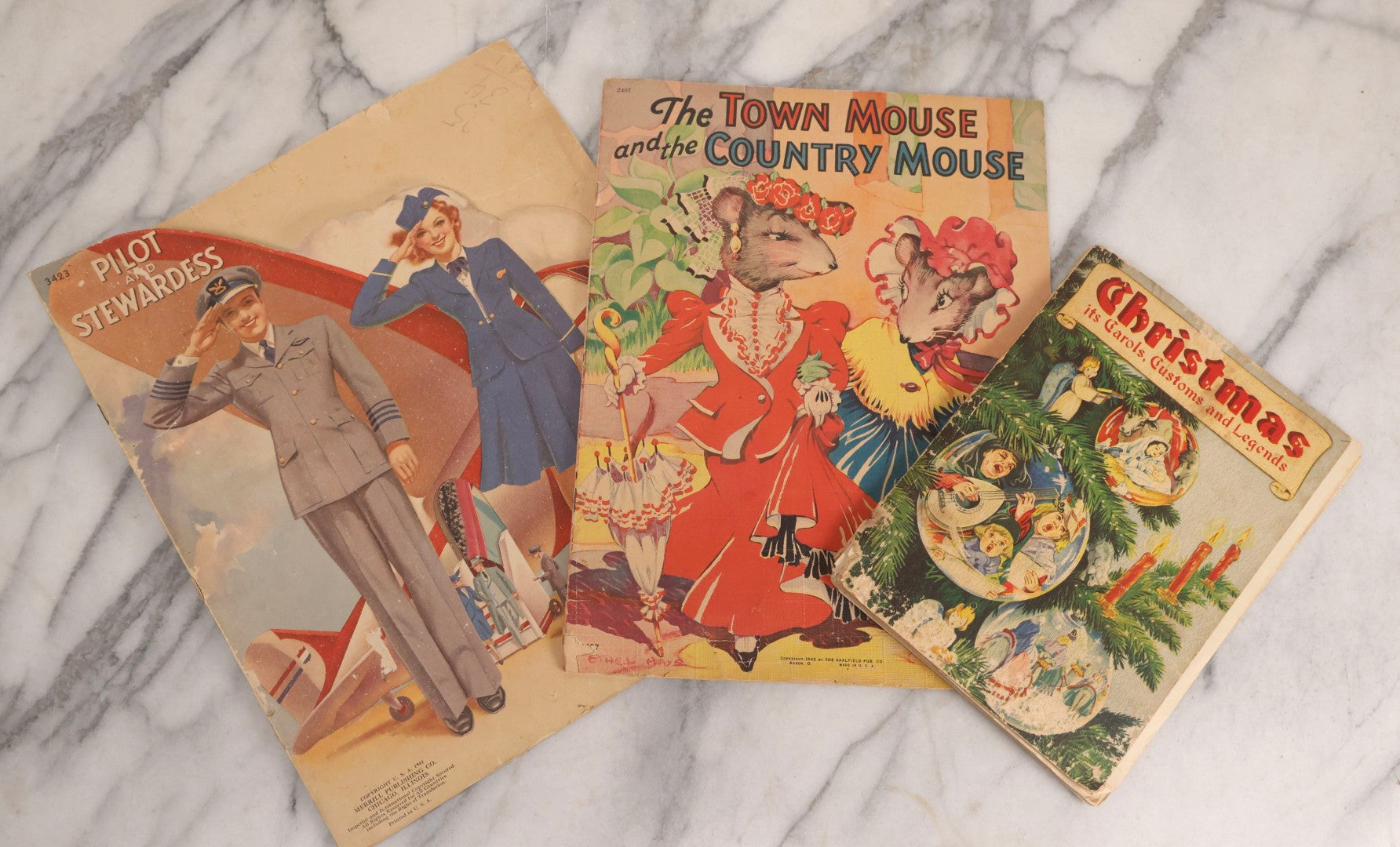 Lot 254 - Trio Of Vintage Children's Ephemera Including Christmas Carols Booklet, Aviation-Themed Paper Dolls, And “The Town Mouse And The Country Mouse” Story Book