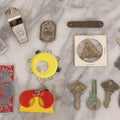 Lot 274 - Grouping Of 13 Vintage Advertising And Metal Pieces Including Ford And Studebaker Keys, Sutter's Hi Speed Turtle Bottle Opener, Acme Thunderer Whistles, S.S. Kresge Co. Feeler Gauge, And Shell Service Scraper