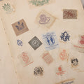 Lot 294 - Antique Scrapbook With Clipped Logos, Seals, And Institutional Names From Colleges, Hotels, Clubs, Banks, Government Offices, And More, Arranged By Color Throughout 20+ Pages, Marbled Cover Boards