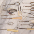 Lot 158 - Grouping Of 16 Antique And Vintage Buttonhooks In Various Materials Including Sterling Silver, Bone, Celluloid, And Mother-Of-Pearl