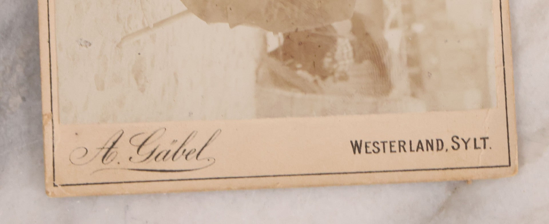 Lot 179 - Antique Board-Mounted Photograph Of Three Mustachioed Men Posed On Beach In Suits With Capes And Walking Sticks Before Striped Beach Windbreak, Westerland, Sylt, Photographed By A. Gabel
