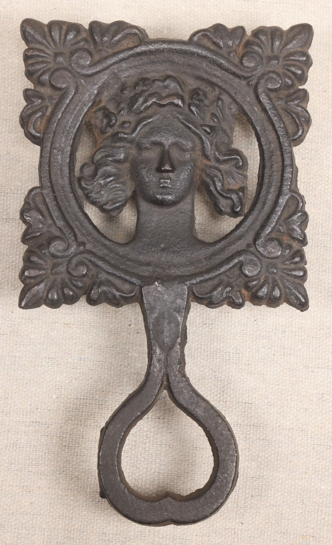 Lot 015 - Antique Cast Iron Figural Trivet With Female Bust And Palmette Corners, Circa Mid-19th Century