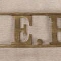 Lot 032 - Antique Brass Name Sign From The E. Hilberg Shaving Parlor, Henry E. Hilberg (1849-1931), Barber, Beaver Falls, Pennsylvania, 31-1/2" Length