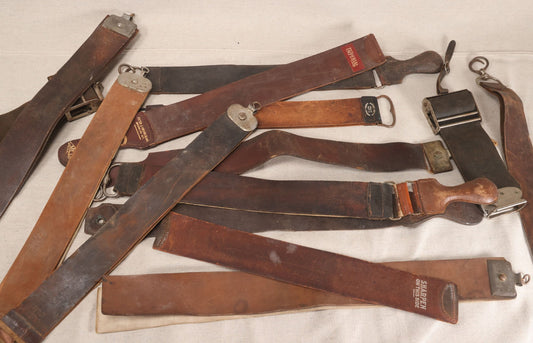 Lot 033 - Grouping Of 13 Antique And Vintage Leather Razor Strops Including Weck Junior, Imperial, Merit By Peter J. Michels, M.L. Brandt Cutlery Co., And Koken's Royal