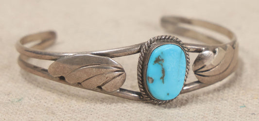 Lot 048 - Vintage Southwestern Sterling Silver And Turquoise Cuff Bracelet With Leaf Appliques And Rope Bezel