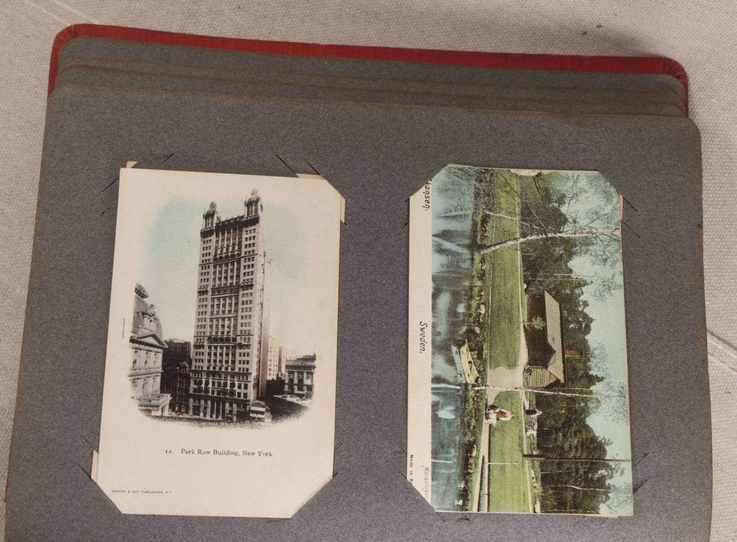 Lot 054 - Antique Postcard Album With Red Cover Containing Approximately 150 Antique And Vintage Postcards, New England, Holidays Including Christmas And Easter, Domestic, And International Subjects